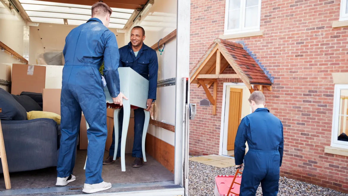 Movers packing household items into boxes, TrekMovers
