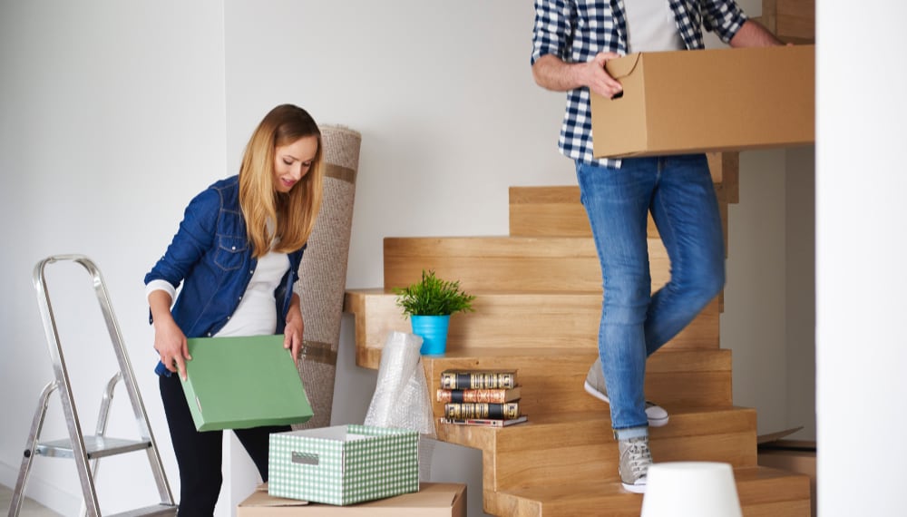 Couple packing boxes together during their move, TrekMovers