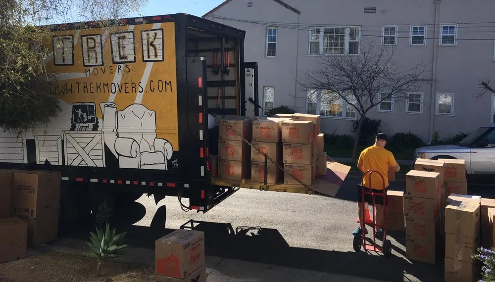 Workers loading boxes into a moving truck, TrekMovers