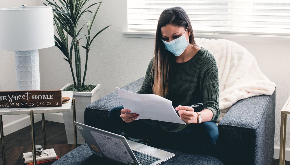 Woman working on a laptop while planning a move, TrekMovers