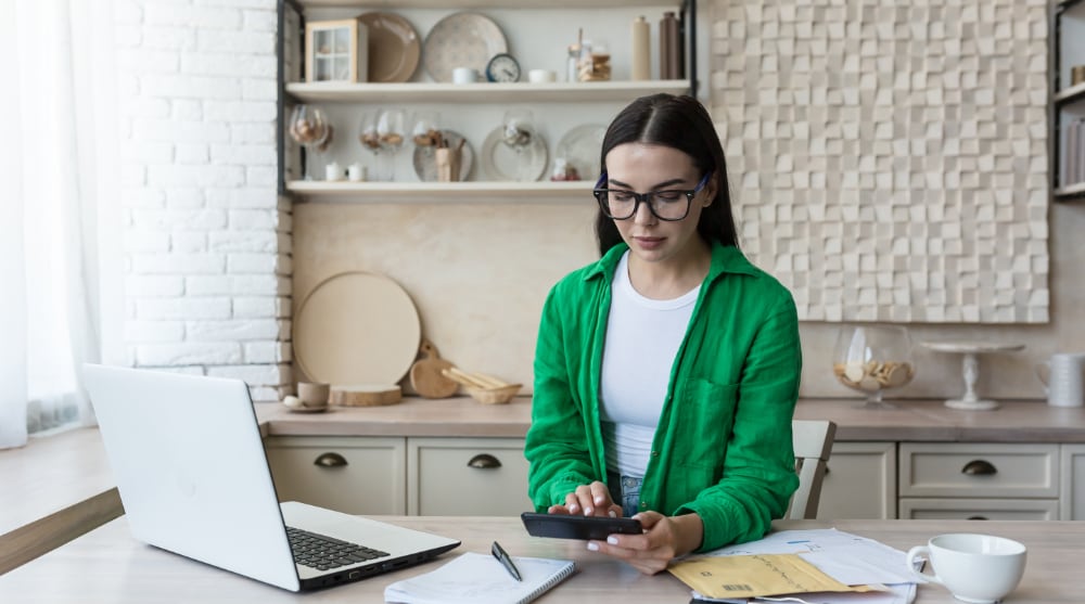 Couple reviewing monthly expenses in their LA apartment, TrekMovers

