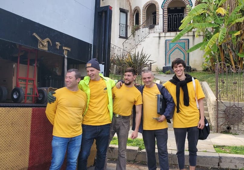 Professional moving team carefully packing and loading furniture with care, TrekMovers